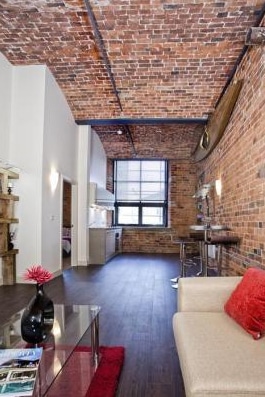 open plan living space with brick walls