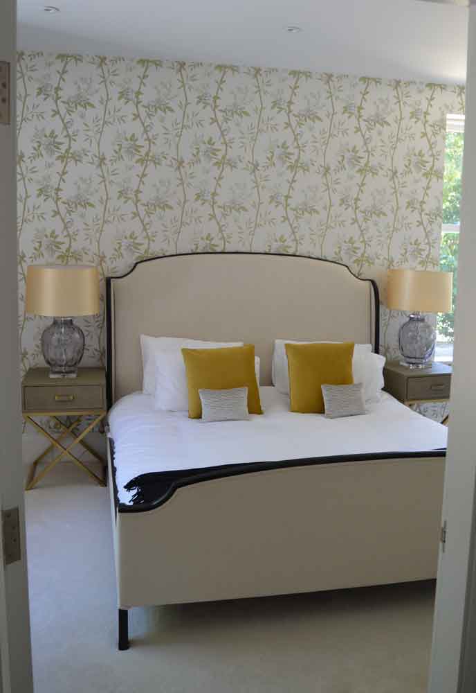 bedroom with large bed and gold bedside tables