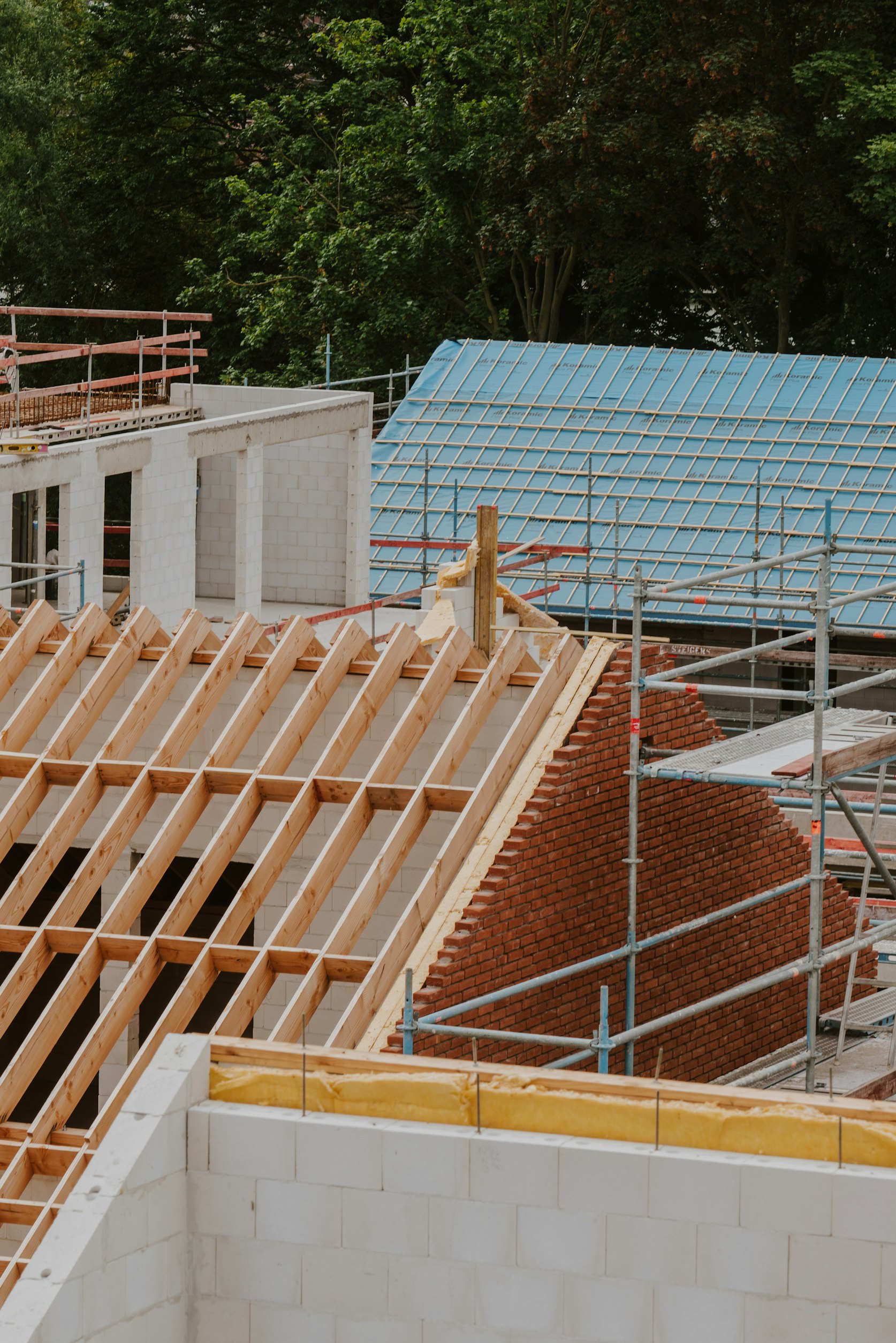 Pitched roof of a residential building under construction with scaffolding